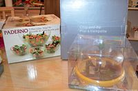 Photo showing three boxed serving items: Paderno salad bowl set, Jole cheese dome, and chip and dip plate.