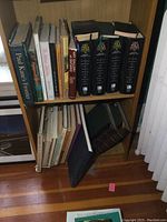 Two lower shelves of wooden bookcase filled with assorted art history books