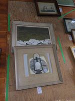 Both paintings hung on plywood wall, showing relative sizes and frames