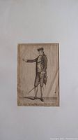 Full-body black and white engraving of an 18th-century male figure, standing with sword and pointing