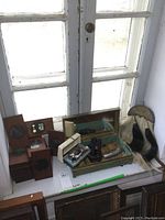Overview of lot items on windowsill: slides, mat cutter, brush, binoculars in case, sporran