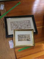 Both framed watercolors on wooden floor, showing relative size and frames.