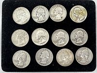 Obverse front view of 12 Silver Washington Quarters on black background showing dates and condition.