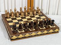 Full view of the stone inlay chess board with all chess pieces positioned on the board showing the classic checkered pattern and border detail.