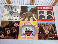 Six Beatles album covers arranged flat: Revolver, Abbey Road, A Hard Day's Night, Rubber Soul, Magical Mystery Tour, Sgt. Pepper's Lonely Hearts Club Band.