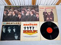 Six album jackets laid out with one loose disc