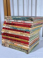 Stack of 19 vintage children's books showing titles and wear on spines with some tape repairs.