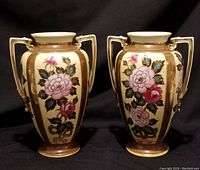 Two matching Noritake porcelain double-handled vases with floral designs and gilded accents, shown front view