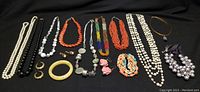 Photo of all costume jewellery pieces laid out on black fabric