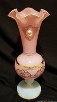Full view of pink opaline vase with ruffled gold rim, gold arabesque patterns on body, white cameo medallion on front.