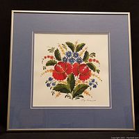 Original Petrykivka style floral painting shown framed with double matting behind glass in silver metal frame