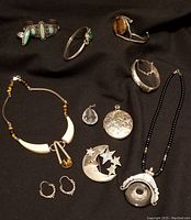 Overview of all jewelry pieces laid out on black background