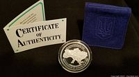 Medallion in plastic case, certificate open, felt holder closed