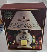 Box showing image of Lenox Holiday Candle Lamp decorated with holly and berries, described as a great gift.