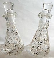 Two Hazel Atlas glass cruets with stoppers, showing overall condition and design.