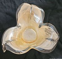 Top view of the Murano glass candy dish showing three-lobed shape and iridescent swirl pattern inside.