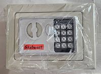 Front view of the Stalwart branded electronic digital steel safe in plastic wrap showing the keypad and lock.