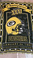 Full view of the Green Bay Packers Super Bowl XXXI 1997 commemorative woven throw blanket showing text, helmet graphic, and date/location.