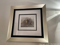 Framed and matted reproduction print showing the overall presentation in a silver and black frame.