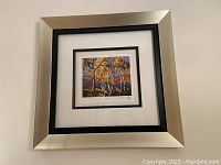 Framed wall art showing the entire piece with silver-tone frame and double matting.