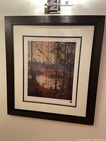 Full view of the framed and matted art print showing a forest river scene in autumnal colors titled Northern River by Tom Thomson.