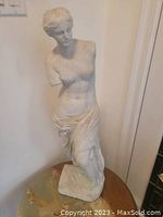 Front view of Venus De Milo concrete statue showing upper body and draped lower body.