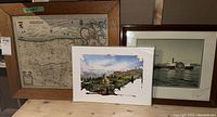 Three framed pieces including a vintage map, a commemorative paddle steamer photo, and one watercolour print.