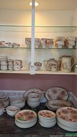 Full display of plates, bowls, cups and serveware on shelving
