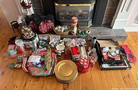 Wide shot showing entire lot of holiday decorations arranged on floor in front of fireplace