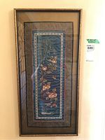 Full view of framed Asian fabric art showing the full shape, colors, and frame.