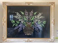 Framed floral painting displayed front-facing showing entire artwork and frame.