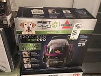 Front view of the Bissell Pet Pro SpotClean cleaner box showing the main product image and branding with a dog photo.