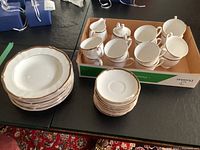 Stack of 9-inch bowls and small saucers on table