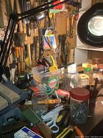 Overall workbench view with assorted bookbinding tools on bench and pegboard
