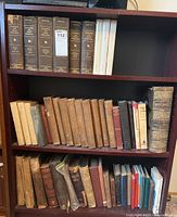 Shelf of hardcover books showing the Canada Great World War series along with other vintage books, some with worn spines and bindings