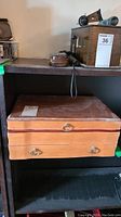 Closed wooden canteen box on shelf