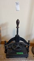 Front view of the entire cast iron book press showing handle and base