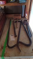 Five hand tools displayed on a shelf