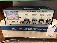 Front view of MFJ Deluxe Versa Tuner II unit on top of the original box showing brand name, model number, and controls.