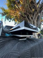 Photo showing the black geometric layered design of the coffee table with reflective glossy surface.