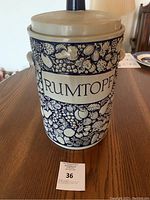 Front view of large Rumtopf crock with blue fruit illustrations and 'RUMTOPF' label