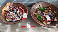 Two large wooden bowls filled with various items; bowl worn and antique with natural patina