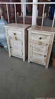 Front view of two white washed reclaimed wood end tables with drawer and cupboard doors, artisan made in India