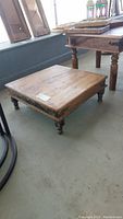 Front and top view of the square Indian tea table showing the wood surface and turned legs.