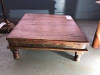 Photo showing Indian square wooden tea table from a slight angle to highlight the whole table and its legs.