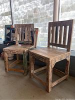 Two rustic artisan reclaimed wood chairs side by side, showing full shape and wood texture.