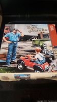 Box front of the Dan Hatala 1000 piece puzzle featuring a man, boy, vintage trucks, and garage scene.