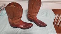 Full side view of both cowboy boots showing the two-tone leather and detailed western-style stitching