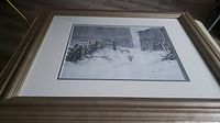 Front of framed print showing the full winter rural scene with snow-covered barn and animals.