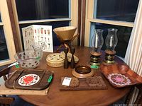 Full view of all items on wooden table in front of windows.
